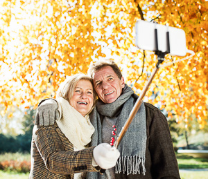 Woman using selfie stick to take travel photo