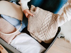 Woman easily packing a suitcase