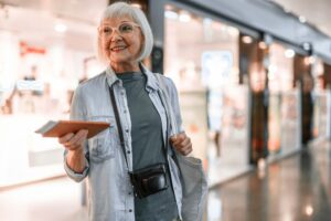 An older woman dressed comfortably for a long-haul flight