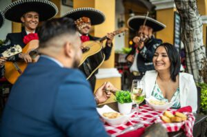 Mariachis serenading a couple in a Mexican restaurant.