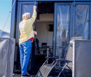 Man putting protective screens on his RV.